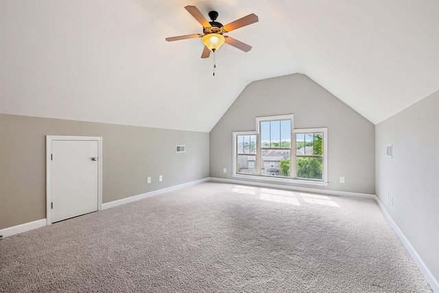 additional living space featuring carpet flooring, vaulted ceiling, a ceiling fan, and baseboards