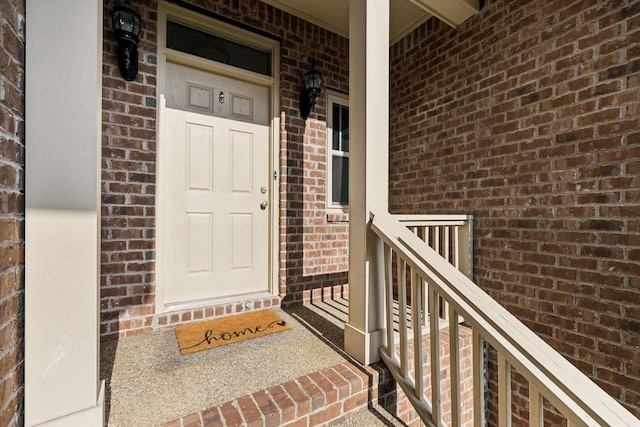 property entrance featuring brick siding and a porch