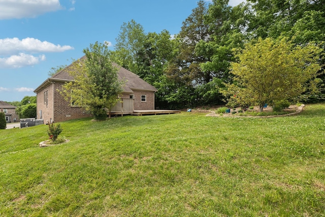 view of green lawn with a deck