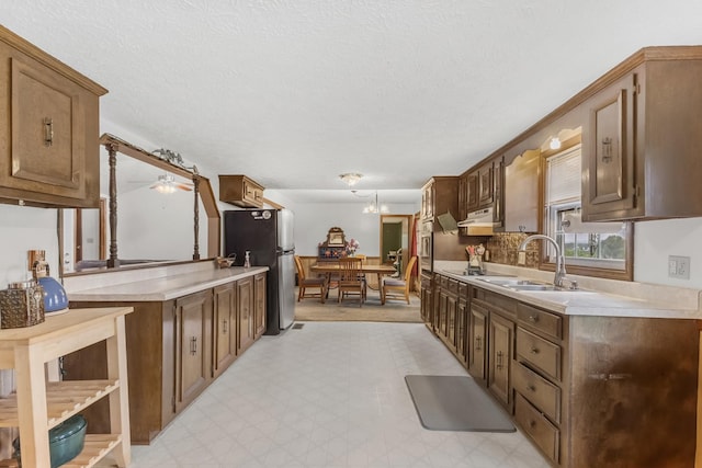 170 School House Ln, Castalian Springs, TN 37031 - kitchen featuring a sink, light countertops, under cabinet range hood, freestanding refrigerator, and ceiling fan