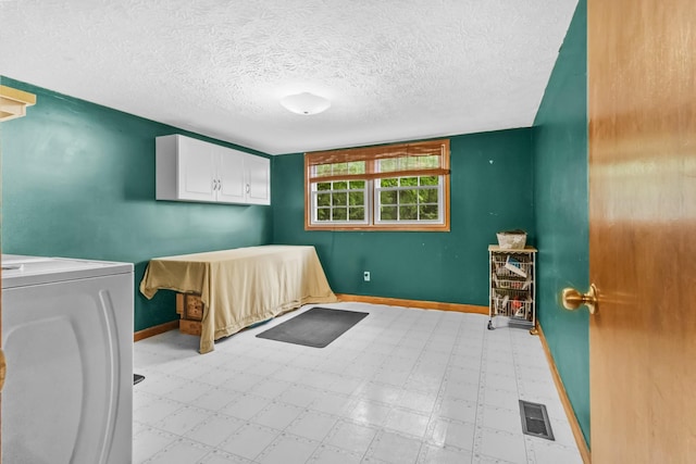 170 School House Ln, Castalian Springs, TN 37031 - unfurnished bedroom with washer / dryer, baseboards, a textured ceiling, and light flooring