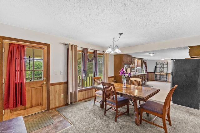 170 School House Ln, Castalian Springs, TN 37031 - dining area with a textured ceiling, a wainscoted wall, a chandelier, and wooden walls