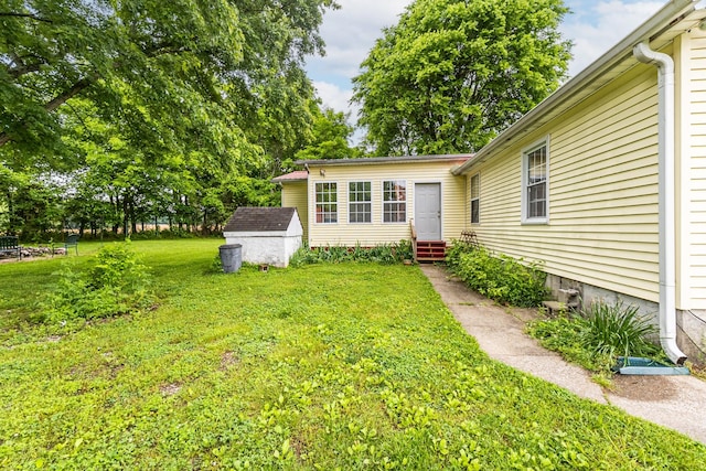 170 School House Ln, Castalian Springs, TN 37031 - view of green lawn with entry steps, a storage unit, and an outdoor structure
