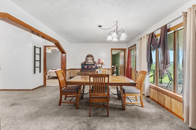 170 School House Ln, Castalian Springs, TN 37031 - carpeted dining area featuring a textured ceiling, a chandelier, wainscoting, and wood walls