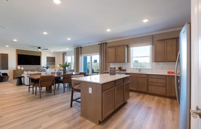 3292 Barrel Oak Pass, Columbia, TN 38401 - kitchen with freestanding refrigerator, a sink, light wood finished floors, a center island, and open floor plan