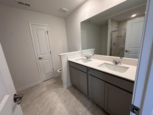 3292 Barrel Oak Pass, Columbia, TN 38401 - full bathroom featuring a shower stall, toilet, double vanity, and baseboards