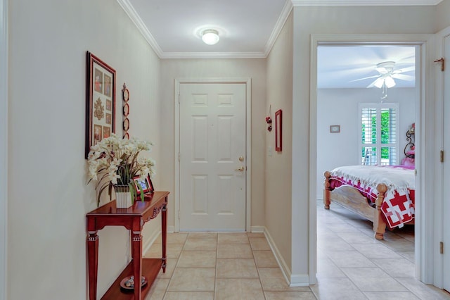 foyer with a ceiling fan, light tile patterned floors, ornamental molding, and baseboards