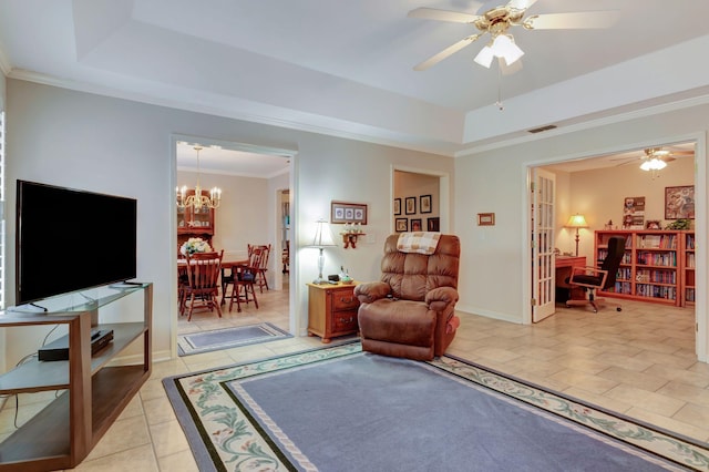 sitting room with a tray ceiling, light tile patterned floors, ceiling fan, crown molding, and a chandelier