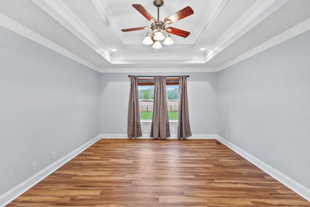 203 Abbigael Dr, Portland, TN 37148 - empty room featuring a tray ceiling, wood finished floors, ceiling fan, crown molding, and baseboards