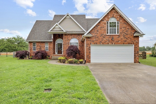 203 Abbigael Dr, Portland, TN 37148 - traditional-style house featuring brick siding, driveway, a front lawn, roof with shingles, and an attached garage