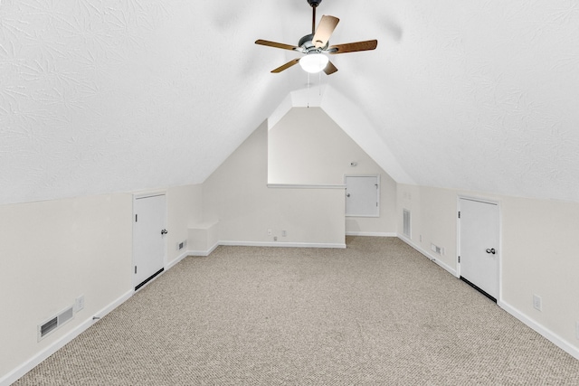 203 Abbigael Dr, Portland, TN 37148 - additional living space with ceiling fan, a textured ceiling, carpet floors, vaulted ceiling, and baseboards
