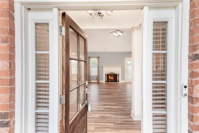 203 Abbigael Dr, Portland, TN 37148 - corridor with light wood finished floors, a chandelier, and brick wall