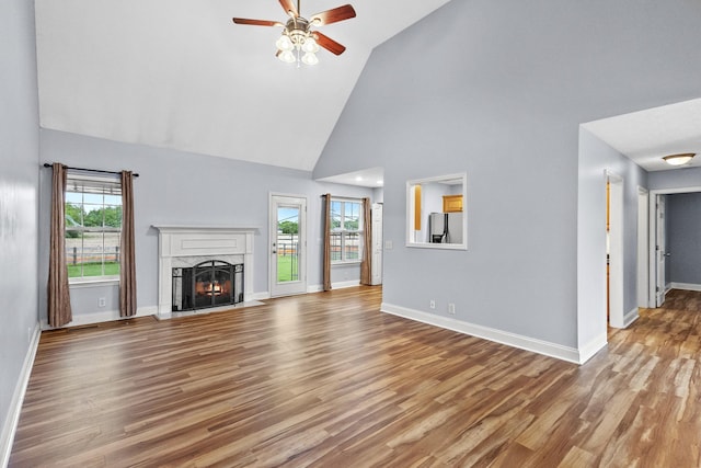203 Abbigael Dr, Portland, TN 37148 - unfurnished living room featuring a ceiling fan, high vaulted ceiling, baseboards, a fireplace, and light wood-style flooring