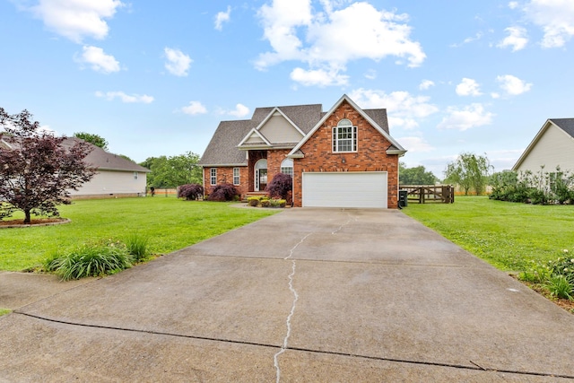 203 Abbigael Dr, Portland, TN 37148 - traditional-style house featuring a garage, brick siding, driveway, and a front lawn