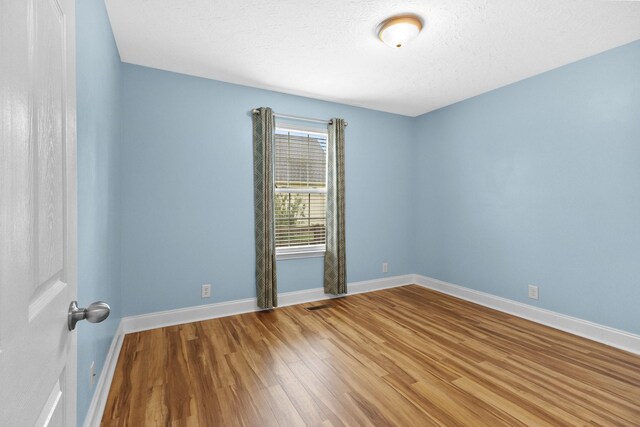 203 Abbigael Dr, Portland, TN 37148 - empty room featuring wood finished floors, baseboards, and a textured ceiling