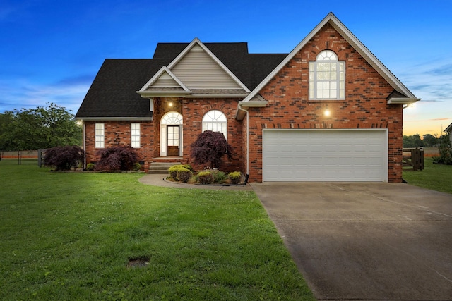 203 Abbigael Dr, Portland, TN 37148 - traditional home with an attached garage, concrete driveway, a lawn, and brick siding