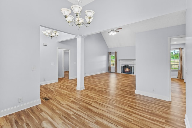 203 Abbigael Dr, Portland, TN 37148 - unfurnished living room featuring a chandelier, healthy amount of natural light, light wood-style floors, a lit fireplace, and high vaulted ceiling