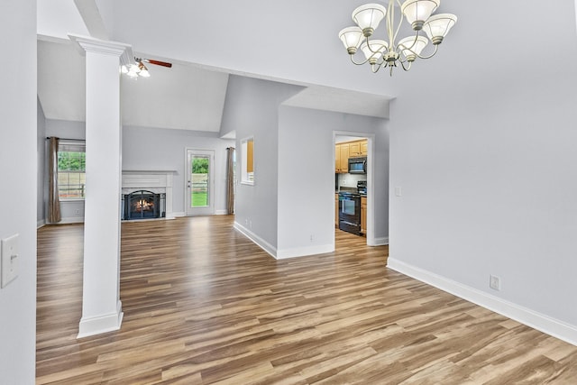 203 Abbigael Dr, Portland, TN 37148 - unfurnished living room featuring wood finished floors, baseboards, high vaulted ceiling, and a warm lit fireplace