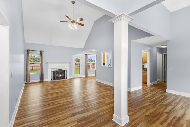 203 Abbigael Dr, Portland, TN 37148 - unfurnished living room featuring high vaulted ceiling, ceiling fan, wood finished floors, a warm lit fireplace, and baseboards