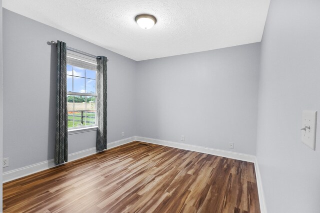 203 Abbigael Dr, Portland, TN 37148 - unfurnished room featuring wood finished floors, a textured ceiling, and baseboards