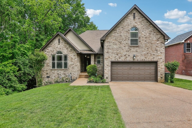349 Woodlands Dr, Gallatin, TN 37066 - view of front of house featuring an attached garage, driveway, a front yard, and brick siding