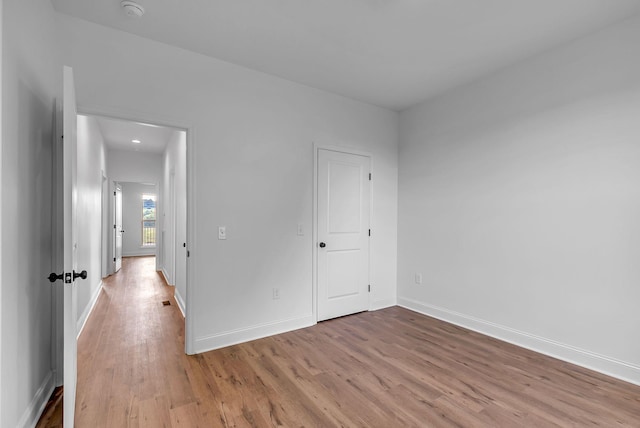 unfurnished bedroom with light wood-style floors and baseboards