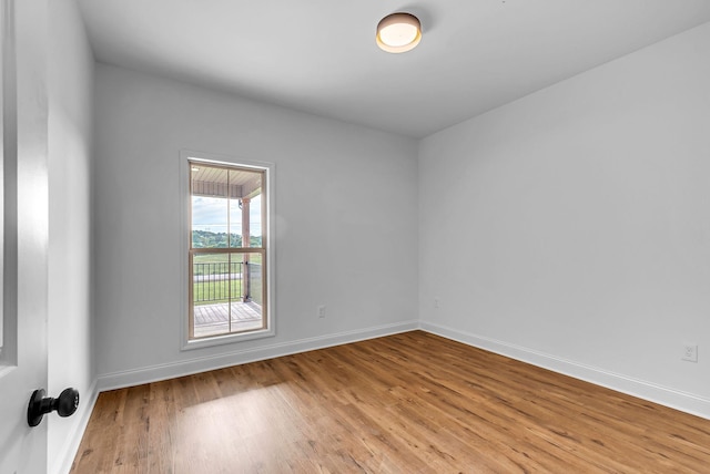 unfurnished room featuring wood finished floors and baseboards