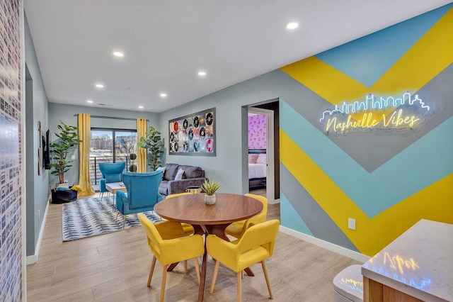 dining space featuring light wood-type flooring, baseboards, and recessed lighting