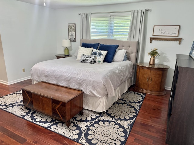 bedroom featuring wood finished floors and baseboards