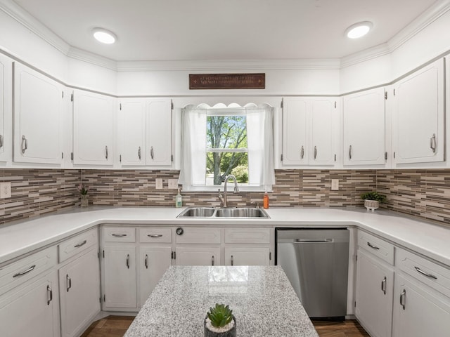 kitchen with stainless steel dishwasher, a sink, white cabinets, and light countertops