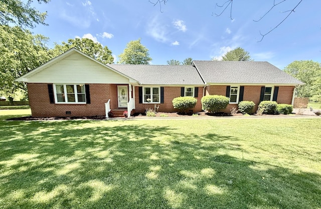 ranch-style house featuring brick siding and a front lawn