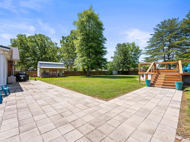 view of patio / terrace with an outdoor structure, a deck, and stairs