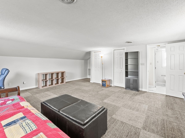 carpeted living area featuring a textured ceiling, vaulted ceiling, and baseboards