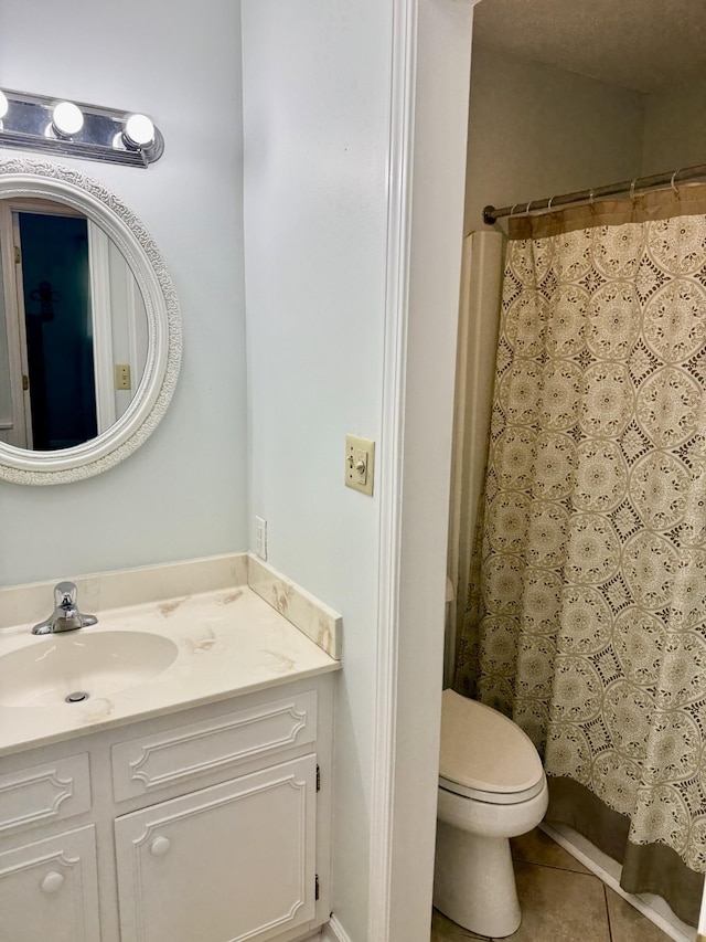 full bathroom featuring tile patterned flooring, toilet, vanity, and curtained shower