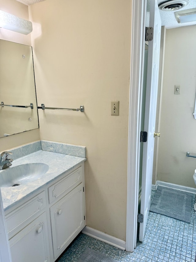 bathroom with vanity and baseboards