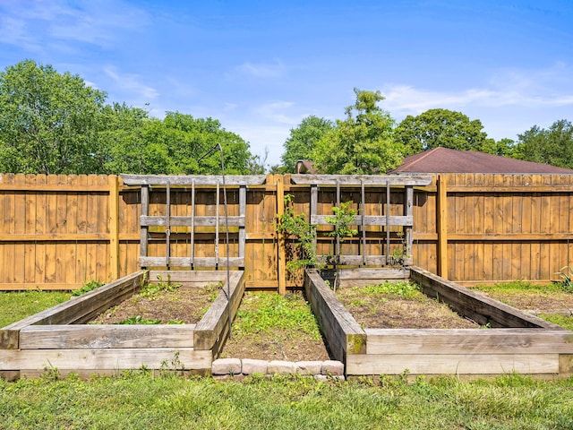 view of jungle gym with a garden and a fenced backyard