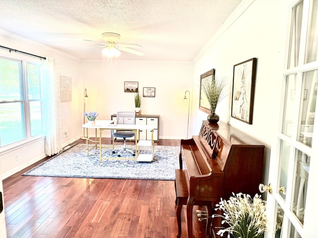 home office with ornamental molding, healthy amount of natural light, hardwood / wood-style flooring, ceiling fan, and a textured ceiling