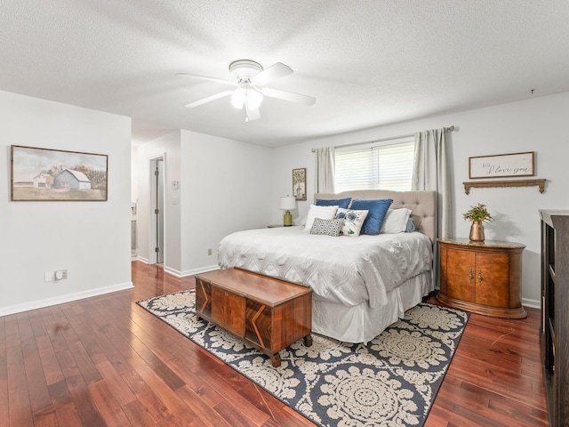 bedroom with hardwood / wood-style flooring, a textured ceiling, baseboards, and a ceiling fan