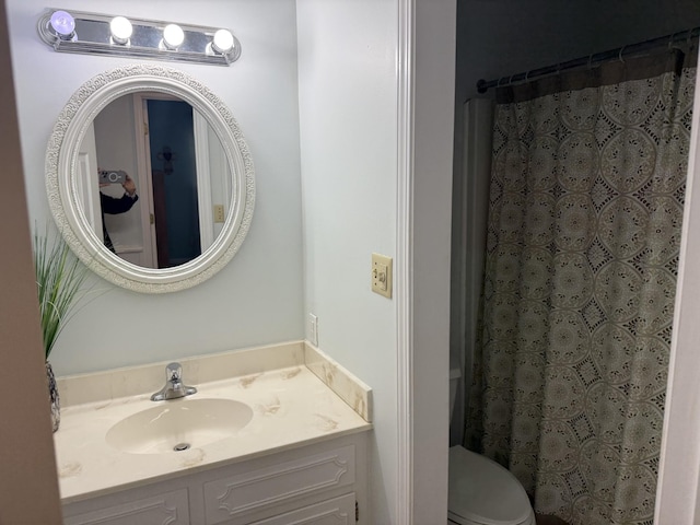 bathroom with vanity, toilet, and a shower with shower curtain