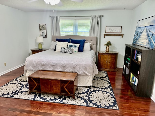 bedroom featuring wood finished floors, baseboards, and ceiling fan