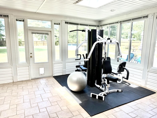 exercise area with stone tile floors and healthy amount of natural light