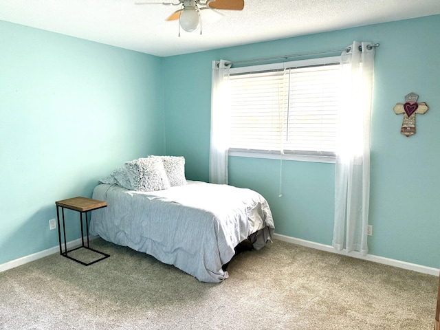 bedroom featuring carpet flooring, a ceiling fan, and baseboards