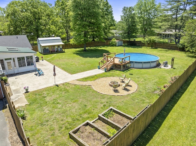 500 Twelve Oaks Rd, Tullahoma, TN 37388 - view of yard featuring an outbuilding, a shed, a patio, a vegetable garden, and a fire pit
