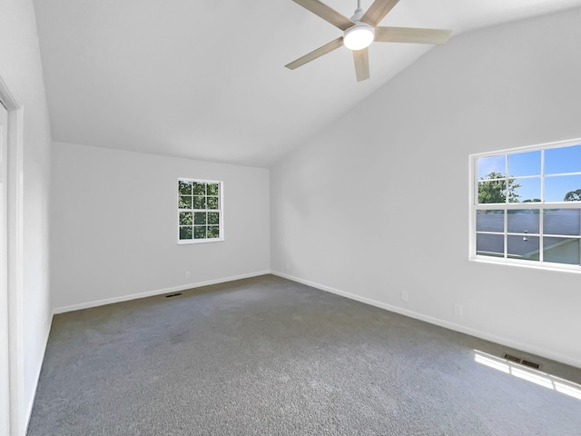 unfurnished room featuring lofted ceiling, ceiling fan, carpet, and baseboards