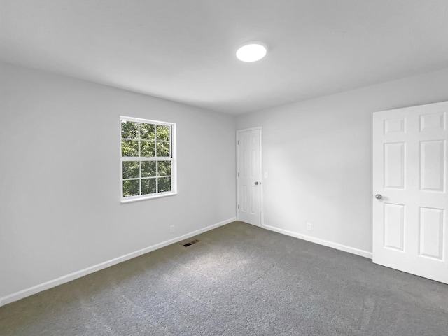 carpeted spare room with baseboards