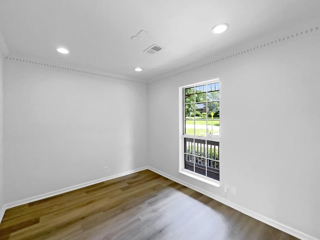 spare room featuring baseboards, wood finished floors, and recessed lighting