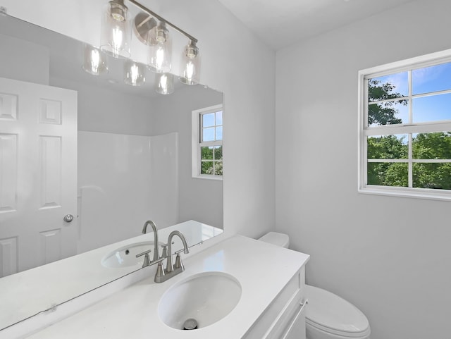 bathroom featuring toilet and vanity