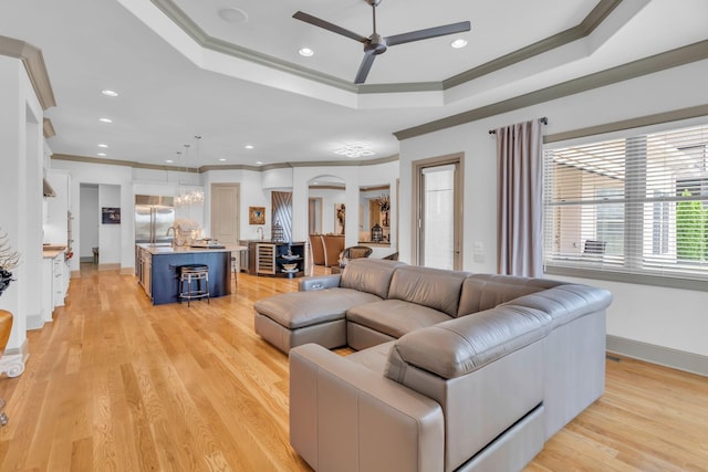 1041 Albatross Way, Gallatin, TN 37066 - living area with ornamental molding, ceiling fan, a tray ceiling, light wood-type flooring, and recessed lighting