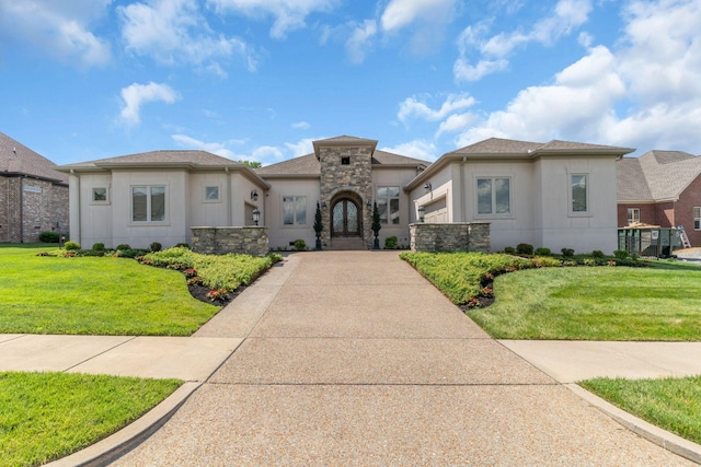 1041 Albatross Way, Gallatin, TN 37066 - view of front facade with a front lawn, stucco siding, stone siding, driveway, and an attached garage