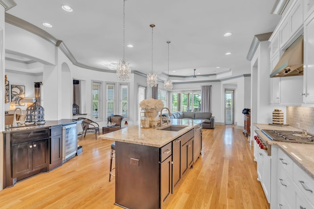 1041 Albatross Way, Gallatin, TN 37066 - kitchen with a sink, open floor plan, wine cooler, ornamental molding, and a kitchen island with sink